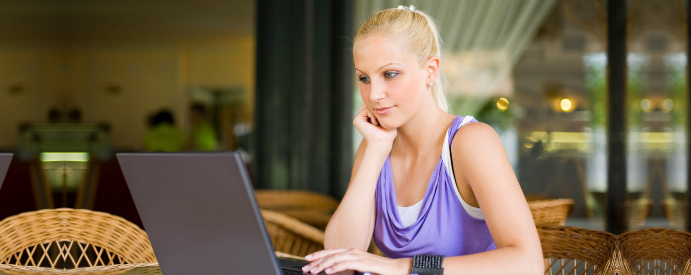 woman smiling in front of her laptop