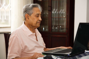 elderly man using computer